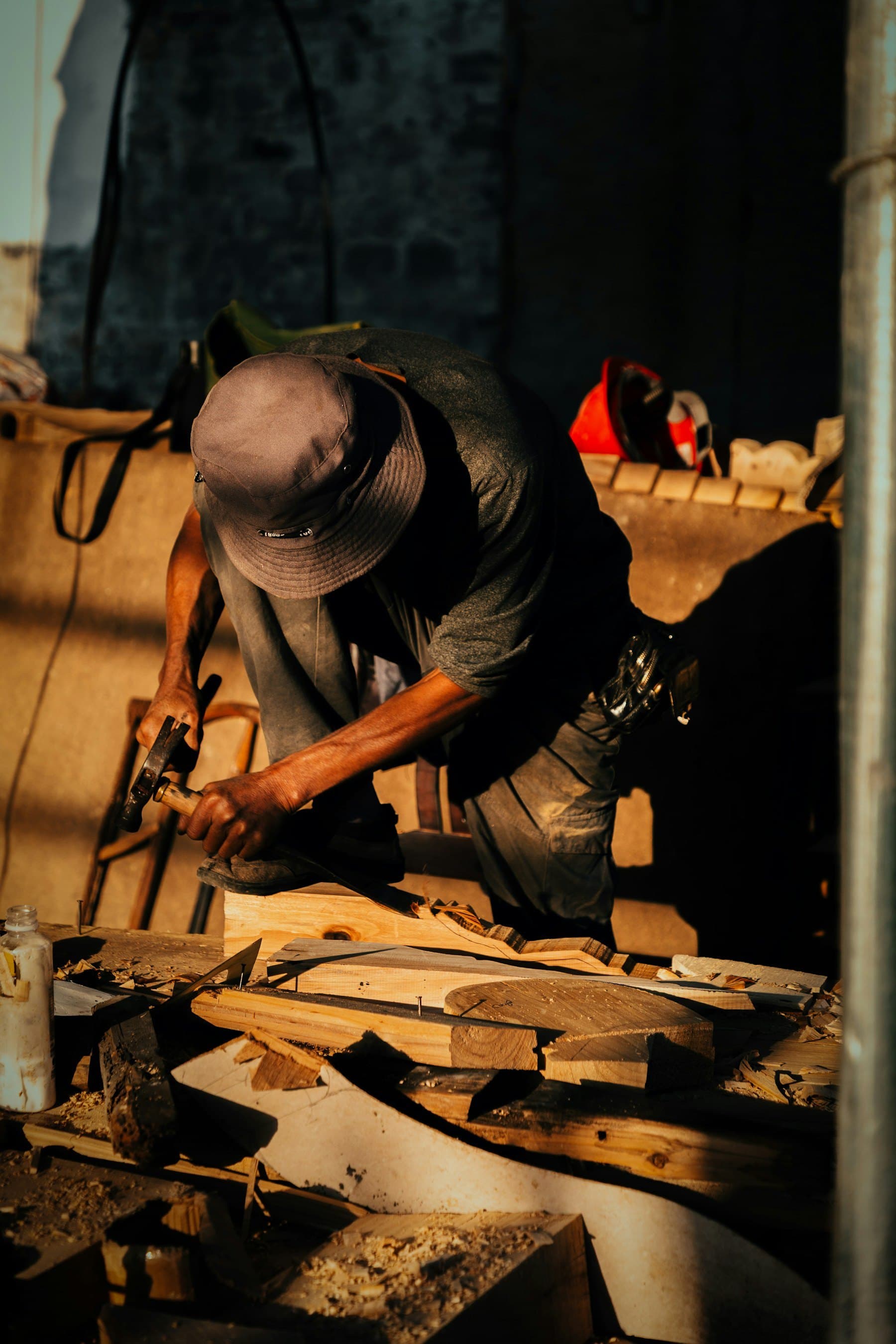 Woodworker shaping a furniture component in a workshop